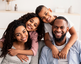 Smiling family outside